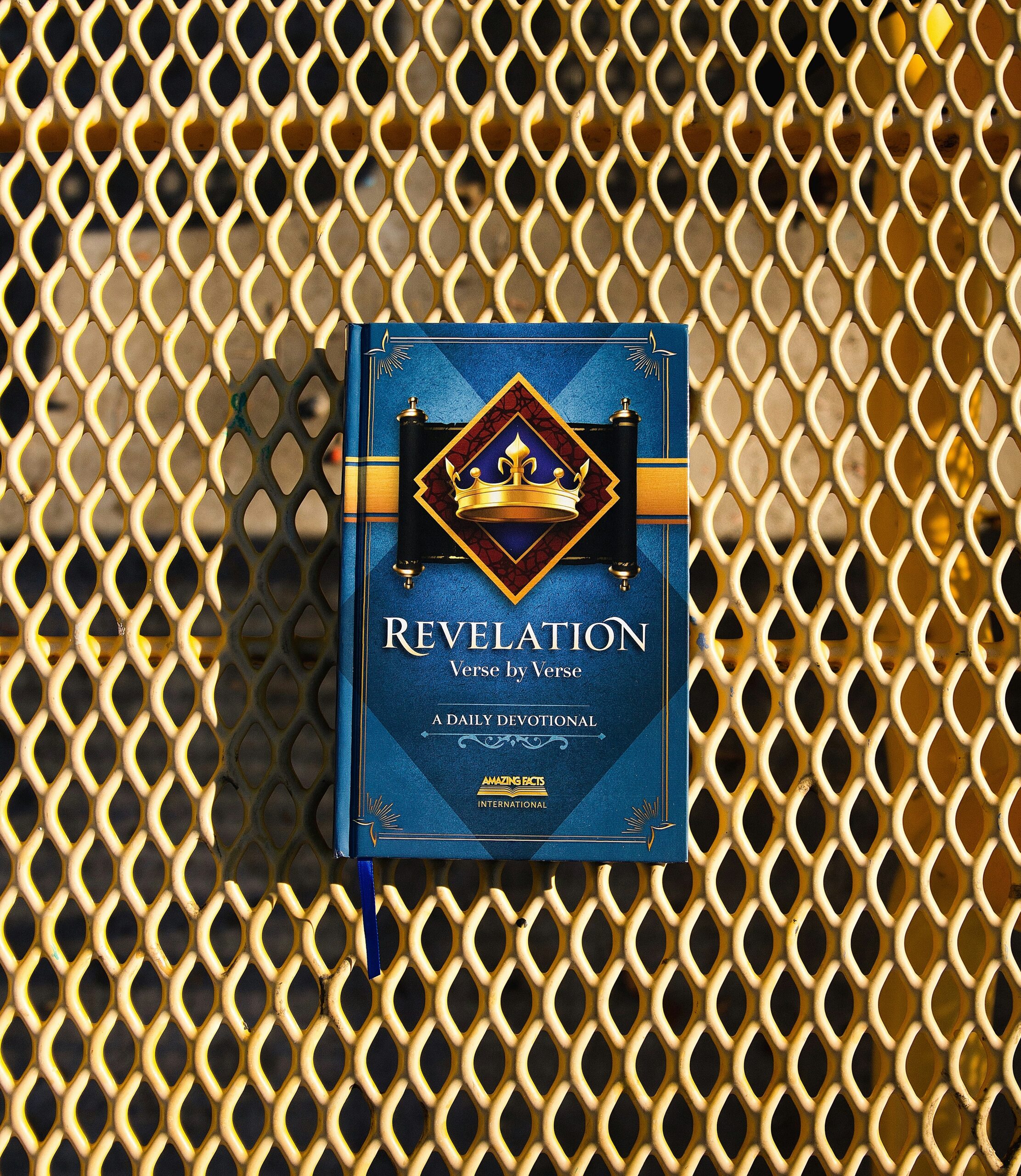 a blue book sitting on top of a metal grate